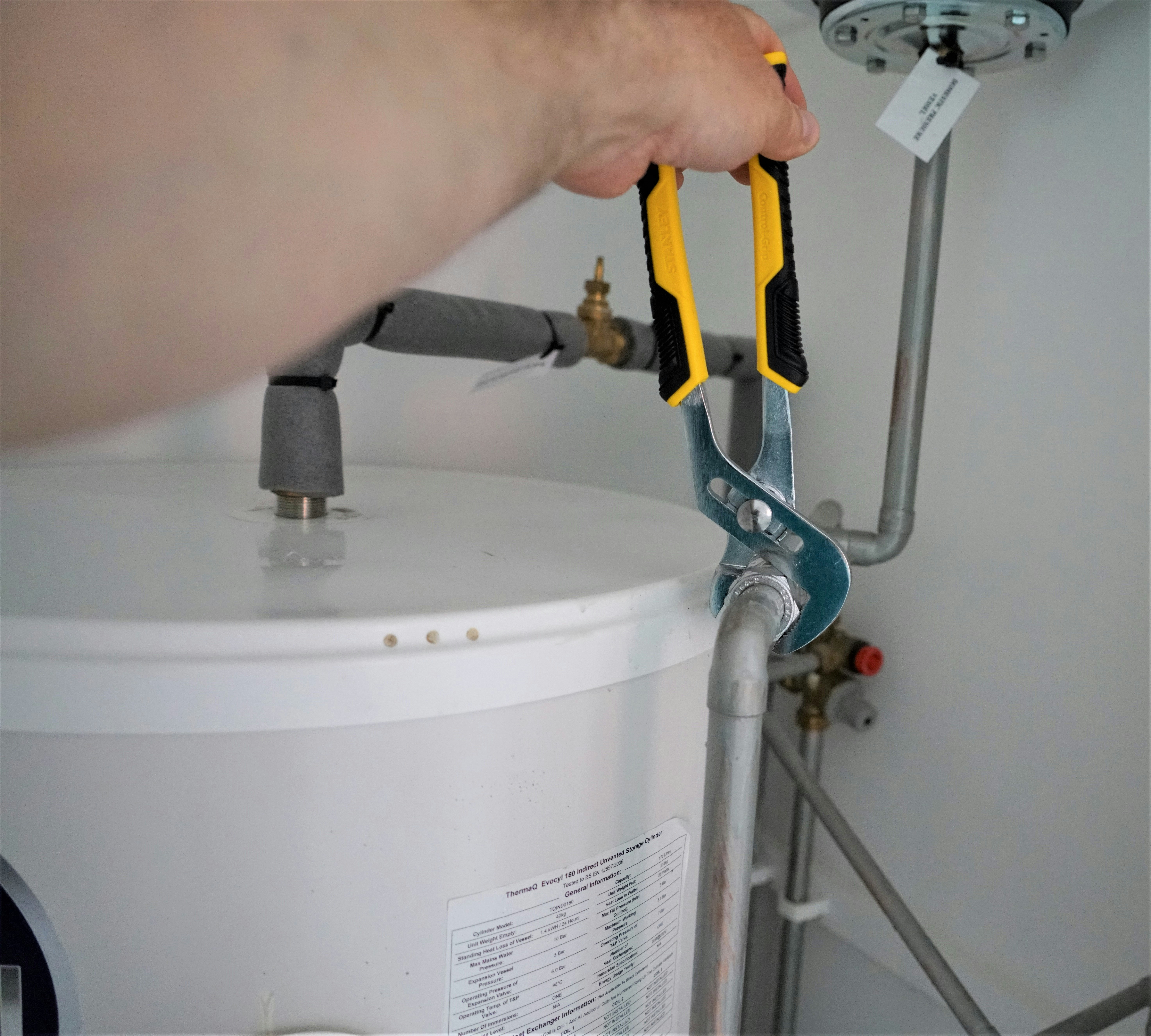 Professional plumber installing water heater